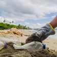 pick up person plastic garbage on beaches, wearing gloves collected from waste in the Caribbean Sea