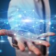 Handsome person holding hologram screen displaying modern cloud based web system technology