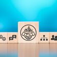 Wooden blocks with symbol of business relationship concept on blue background