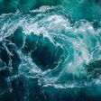 Waves of water of the river and the sea meet each other during high tide and low tide. Whirlpools of the maelstrom of Saltstraumen, Nordland, Norway
