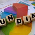 The concept of the word funding on cubes against the background of the graph