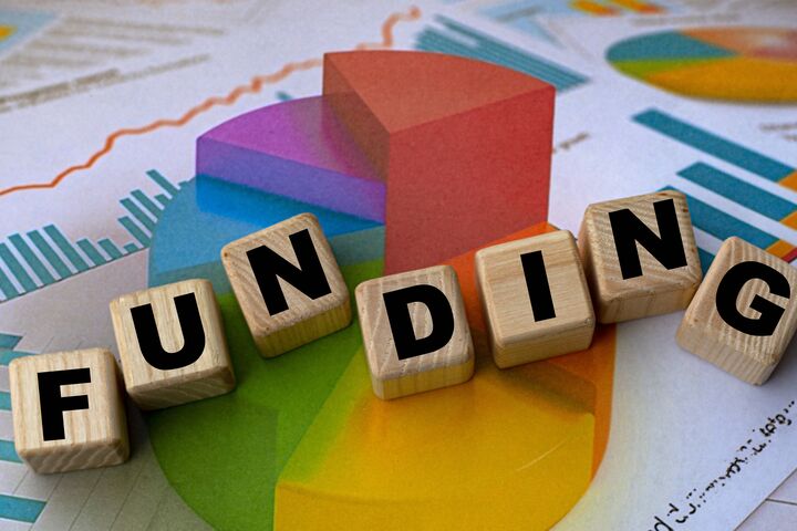 The concept of the word funding on cubes against the background of the graph