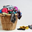 Overflowing laundry basket. Household chore concept on white background