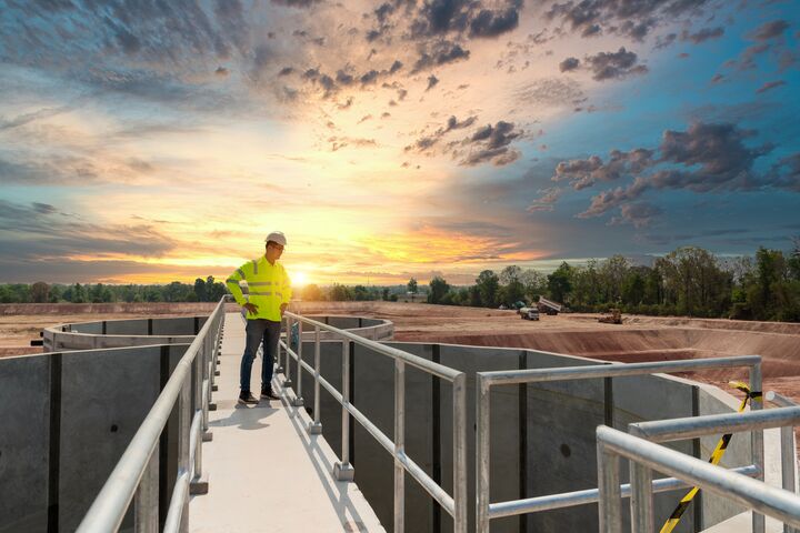 Civil Engineer inspects the construction of a large sewage-water treatment pipe unfinished