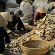 Vietnamese women sorting non-hazardous electronics and appliance waste.