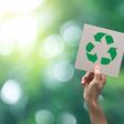 Hand holding recycle symbol on green bokeh background. eco and save the earth concept.