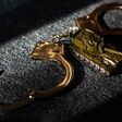 toy tank and handcuffs on a dark background