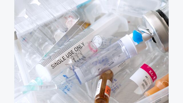 medical syringes and ampoules of plastic and glass that were in use, waste, close-up
