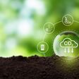 Reduction of carbon emissions, carbon neutral concept. Net zero greenhouse gas emissions target. Reducing carbon footprint concept. Decreasing CO2 emissions target symbol on green view background.