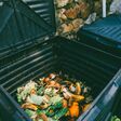 Close up view of organic waste inside compost bin. Organic farming and healthy lifestyle concept