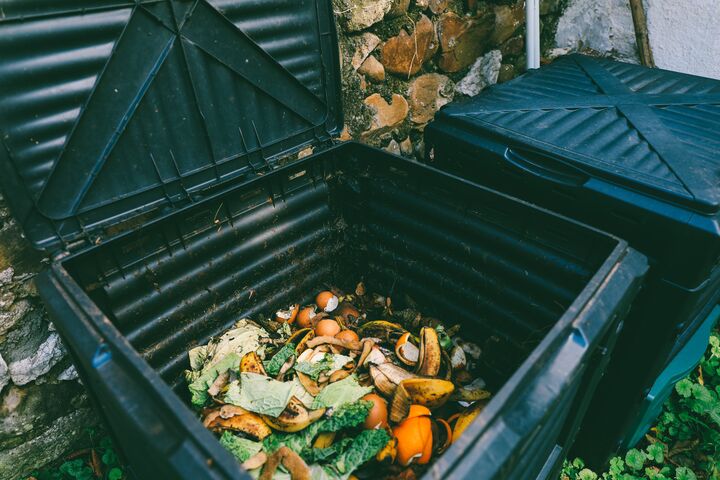 Close up view of organic waste inside compost bin. Organic farming and healthy lifestyle concept