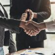 Business people shaking hands, finishing up meeting, business etiquette, congratulation, merger and acquisition concept.