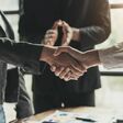 Business people shaking hands, finishing up meeting, business etiquette, congratulation, merger and acquisition concept