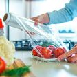 Woman using food film for food storage