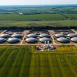 Production of sustainable fuel called bio gas. New factory in field. View from above. Ecological production concept