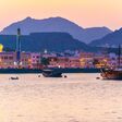 View of coastline of Muttrah district of Muscat during sunset, Oman.