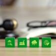 The environmental law or politician with nature and environment-friendly values. Green wooden cubes with a decarbonization icon and green icon.Sustainable development.global warming and conservation.