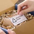 Eco vendor go green packaging parcel carton box in net zero waste store asian seller retail shop. Earth care day small SME owner asia people wrap reuse brown paper pack gift reduce plastic free order.