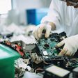 techie sorting e-waste, separating recyclable materials and removing hazardous materials, created with generative ai