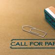 3D illustration of rubber stamp over paper background with the text call for papers. Conference or meeting organization and communication