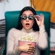 IFAT - erstaunte Frau mit. Sonnenbrille und Popcorn