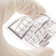 Technician holding a flexible electric circuit layout