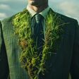 A businessman in a suit made from grass and moss, symbolizing green jobs and sustainable business practices. Emphasizing a nature-friendly and ecological approach to modern business.