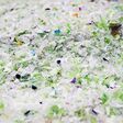 Recycled plastic bottles. Polymeric pellets. Polymer beads. Polyethylene granules. Renewable resource.