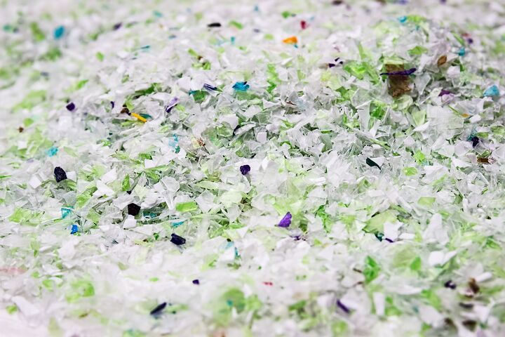 Recycled plastic bottles. Polymeric pellets. Polymer beads. Polyethylene granules. Renewable resource.