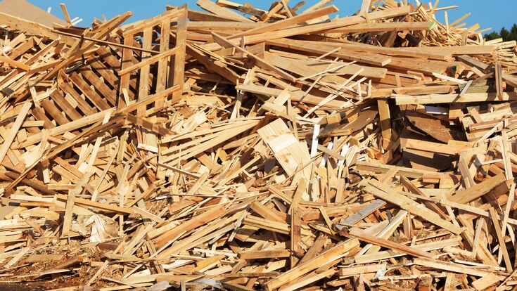 A large pile of wooden debris mostly from planks and pallets.