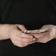 cropped view of man counting dollar banknotes isolated on black