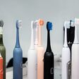 Many different colored ultrasonic toothbrushes on display in a store. Daily dental care for healthy teeth. Selective focus.