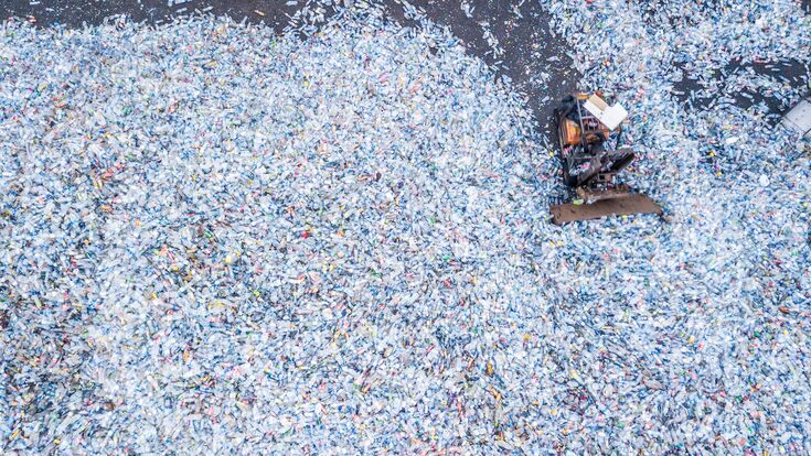 Aerial top view large garbage pile, Garbage pile in trash dump or landfill, Waste from household in waste landfill, waste disposal in dumping site, excavator machine is working on a mountain garbage.