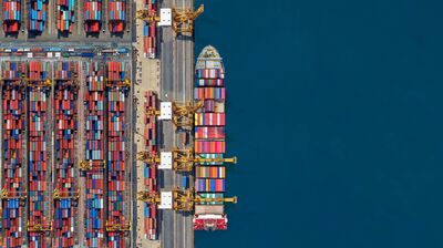 Industrial import-export port prepare to load containers. Aerial top view container ship in export and import global business and logistic. Global transportation and logistic business.