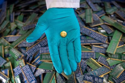 Royal Mint, Wales, United Kingdom, UK, 2024, Hand holding gold